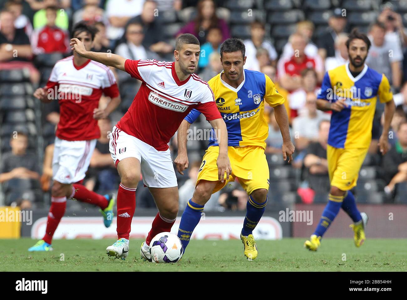 Fulham's Adel Taarabt (left) and Parma's Marco Marchionni battle for the ball Stock Photo