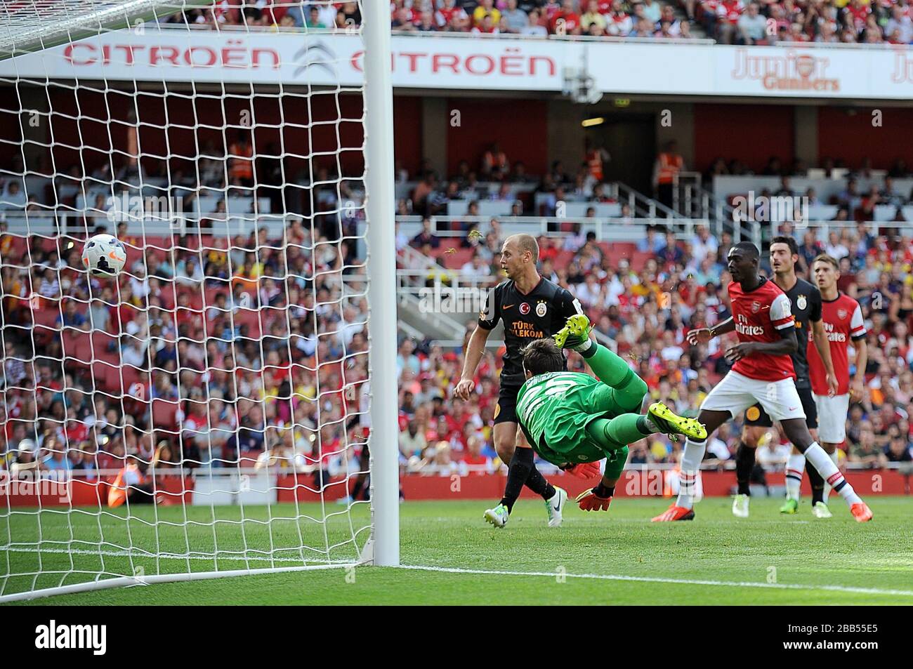 Galatasaray goalkeeper Fernando Muslera fails to stop a shot from Arsenal's Theo Walcott (not in picture) for their first goal of the game Stock Photo