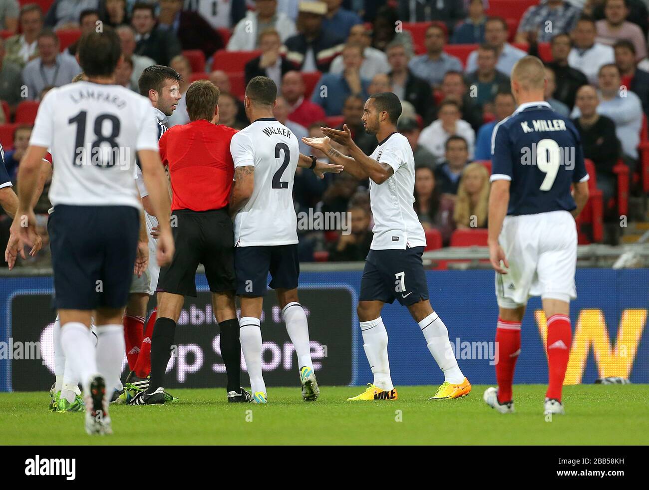 Tempers flare between England's Theo Walcott (right) and Scotland's Robert Snodgrass (left) Stock Photo