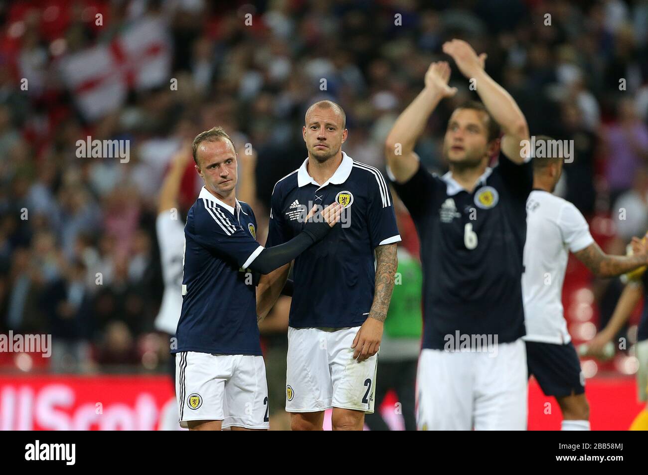 Scotland's Alan Hutton (centre) and teammate Leigh Griffiths  look dejected after the final whistle Stock Photo