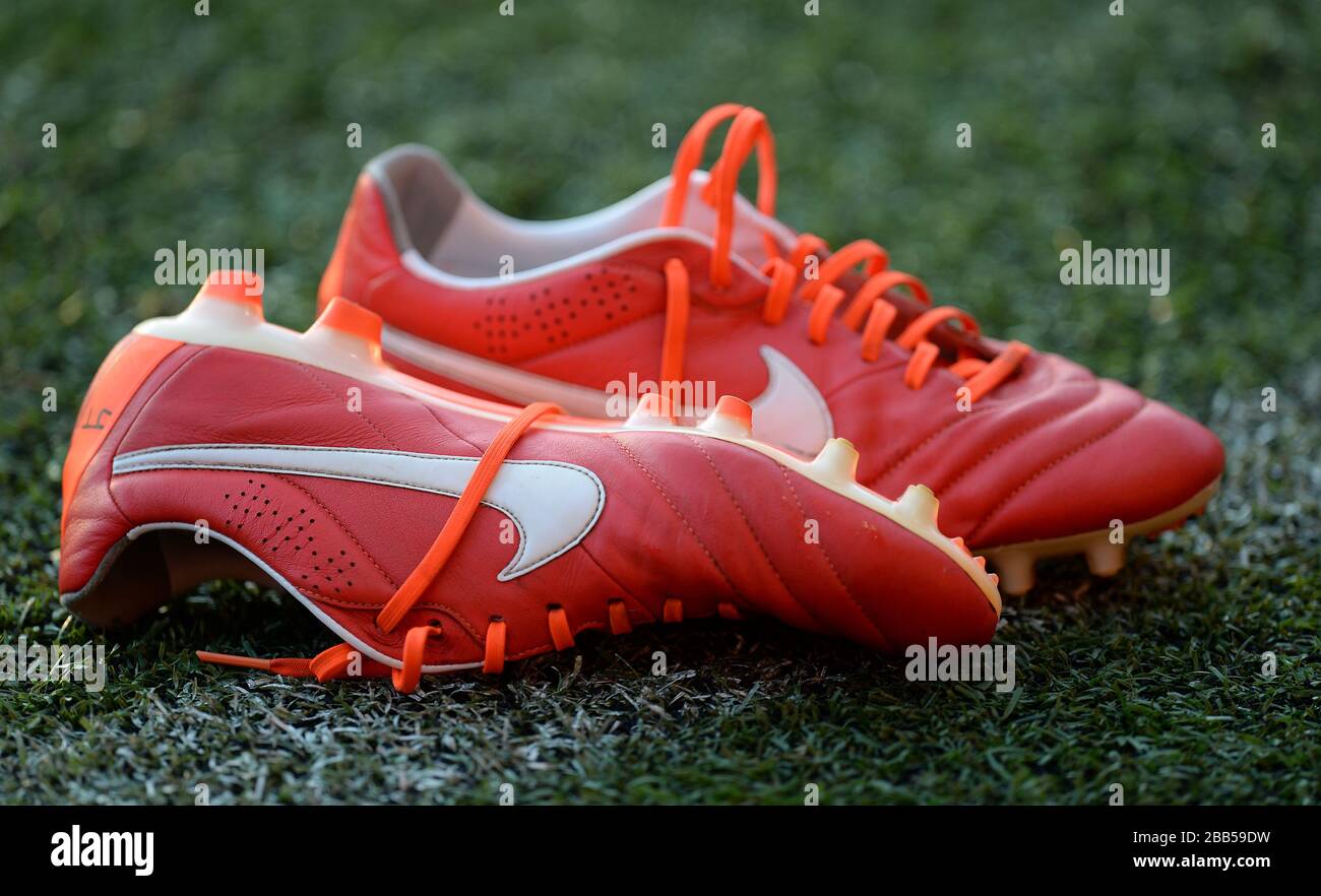 General view of a pair of Red Nike football boots on the pitch Stock Photo  - Alamy