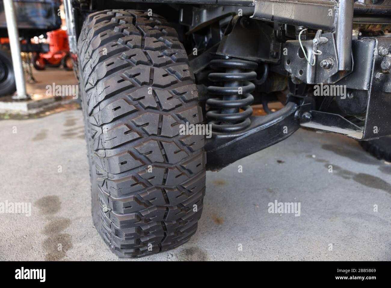 Close-up new military jeep tire and car suspension of an vintage jeep at outdoor Stock Photo