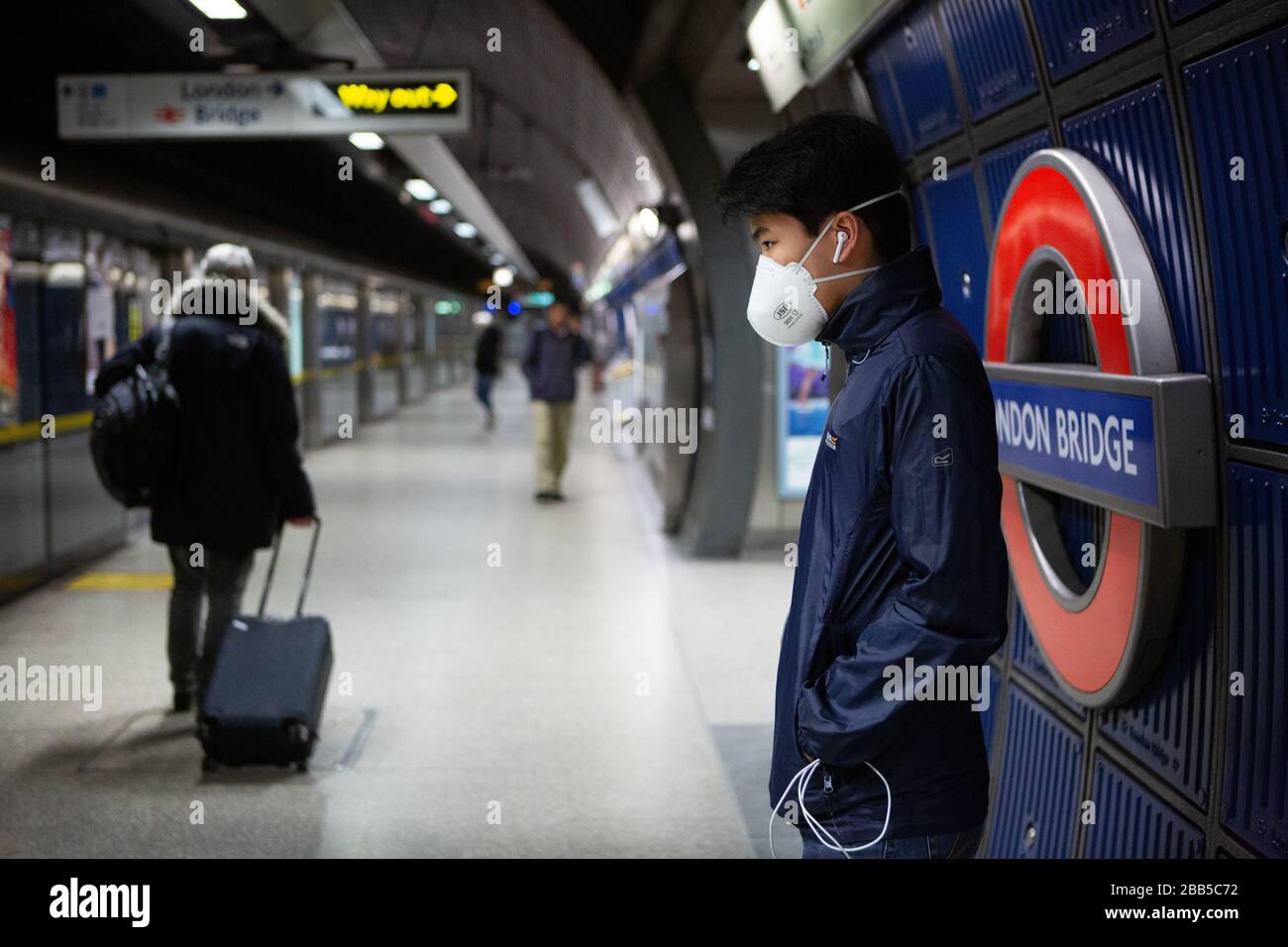 Commuters wearing face masks on the London Underground travelling