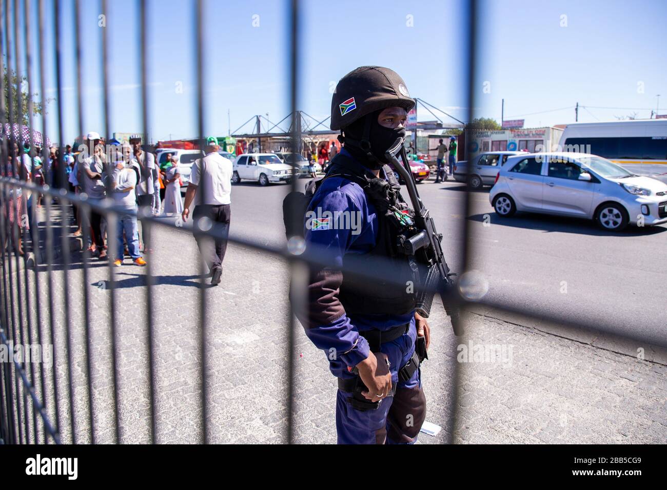 Cape Town, South Africa. 30th Mar, 2020. a member of TSU Protection Services stands guard at a SASSA paypoint inside a shopping centre in Makhaza, Khayelitsha, after the South African government declared a 21 day COVID-19 lockdown as part of the State of National Disaster declaration by President Cyril Ramaphosa. The Health Ministry has asked residents to observe the regulations, practise hygiene, stay at home and practise social distancing. Credit: Roger Sedres/Alamy Live News Stock Photo