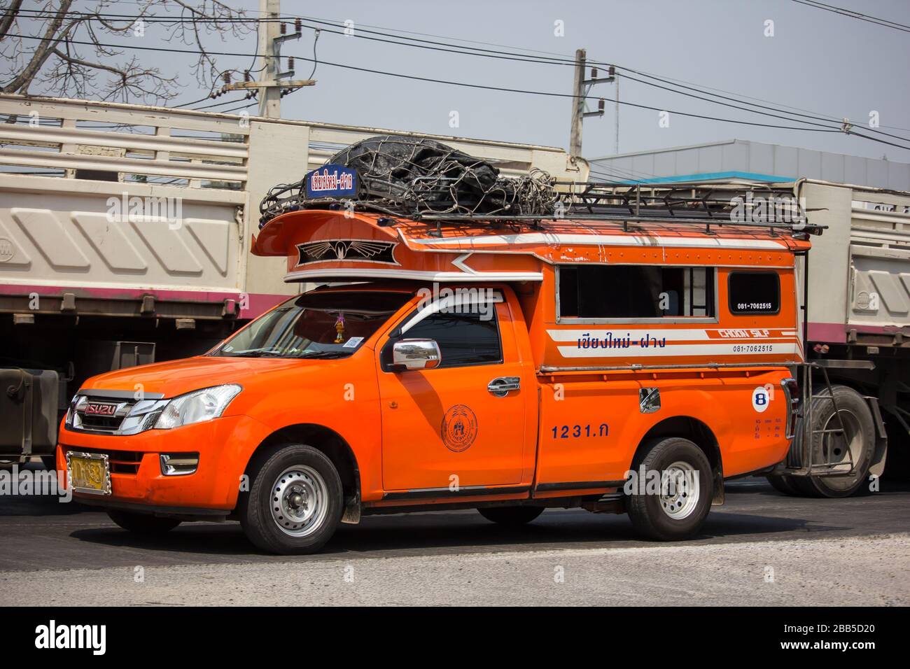 Chiangmai, Thailand - March  4 2020: Orange Pickup truck taxi Chiangmai to Fang.  On road no.1001, 8 km from Chiangmai Business Area. Stock Photo