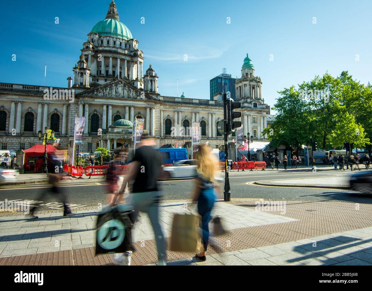 Belfast, Norther Ireland people walking in front of Belfast City Hall