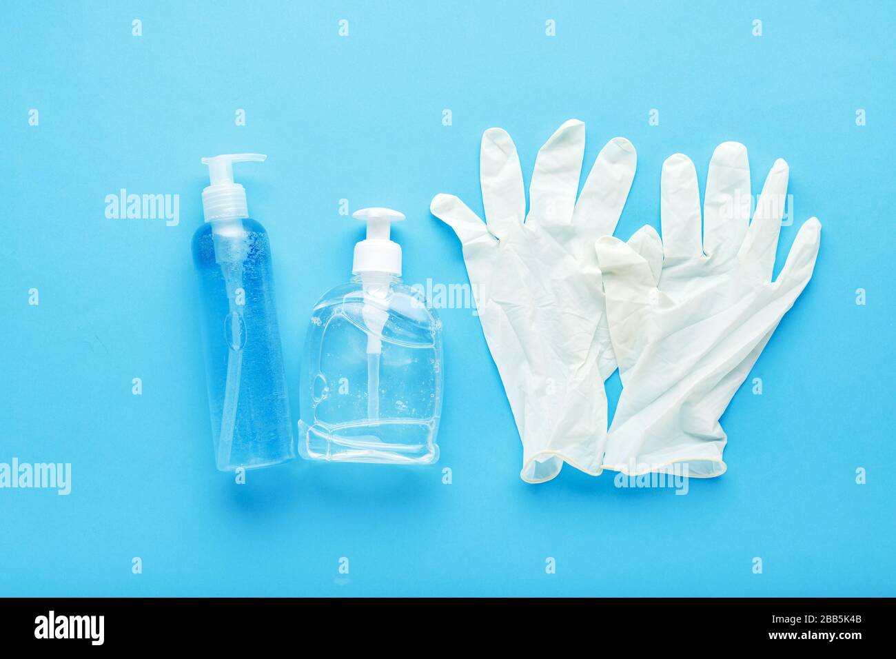 Hand hygiene, rubber gloves, different bottles of hand sanitizers, antiseptic gel. Virus protection, antibacterial gel, soap.Concept of medicine Stock Photo