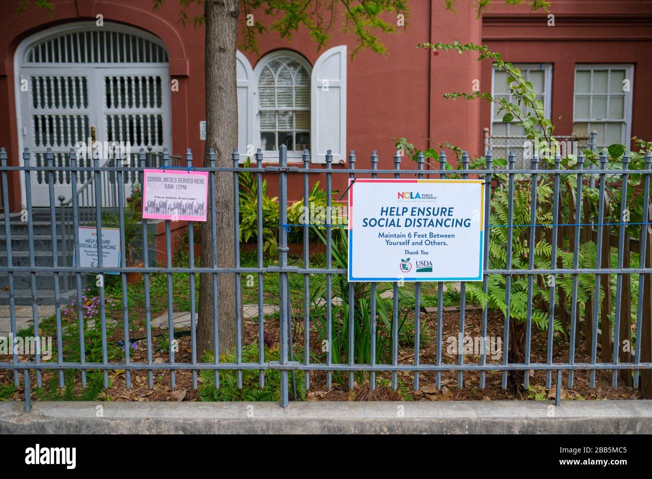 New Orleans, LA/USA - 3/21/2020: Help Ensure Social Distancing Sign at Plessy School in the French Quarter Stock Photo