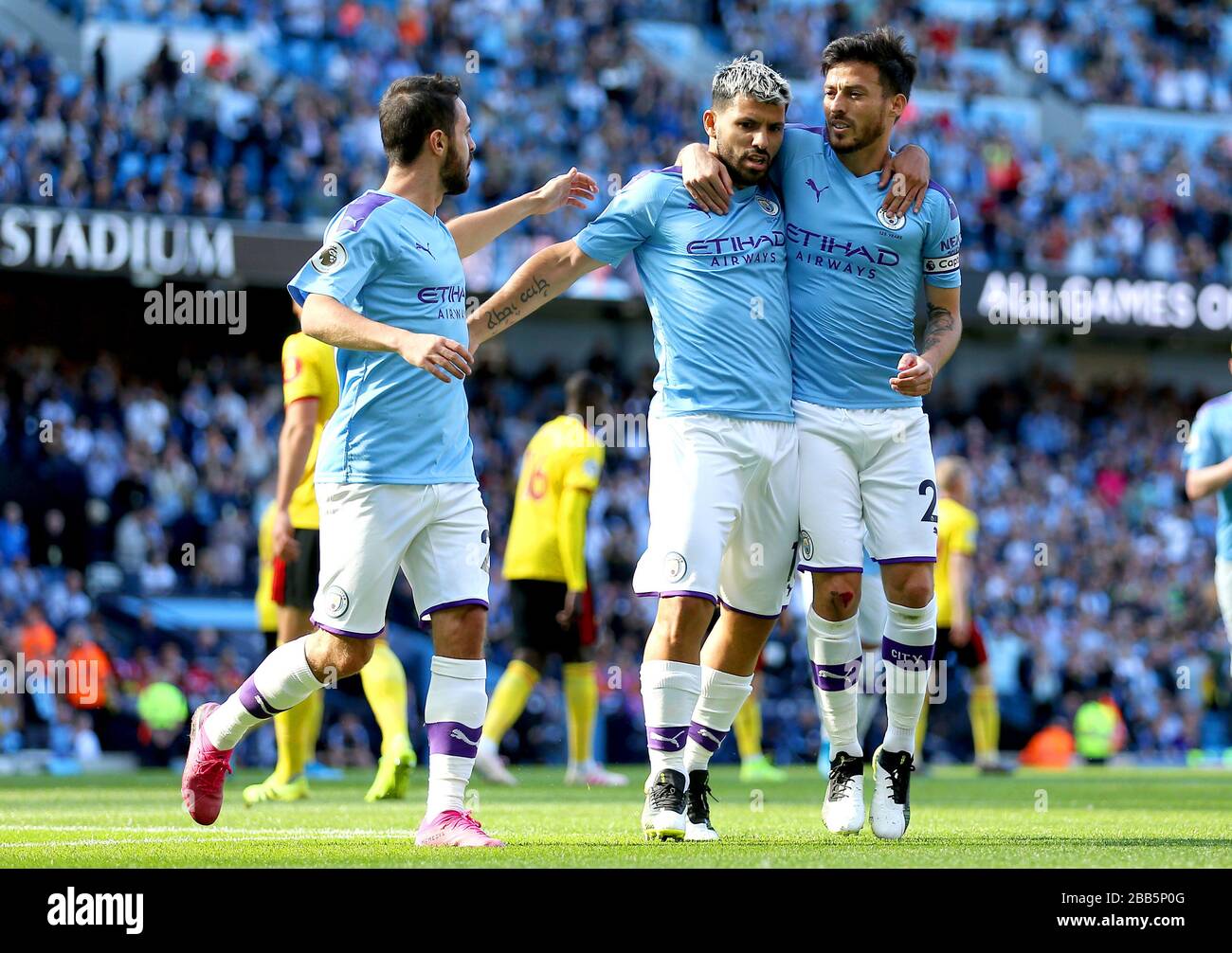 Manchester City's Sergio Aguero (centre) celebrates scoring his side's second goal of the game with his team mates David Silva (right) and Bernardo Silva Stock Photo