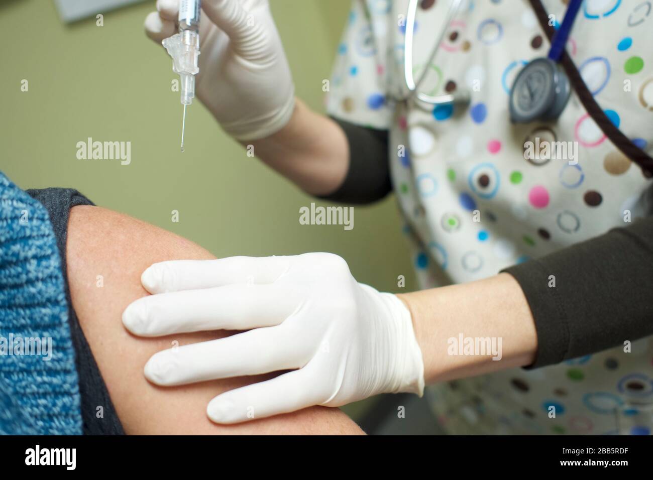 Nurse preparing to administer vaccine, Coronavirus, Covid-19 or Influenza shot. Skilled nurse in doctor's office or hospital immunizing and prevention Stock Photo