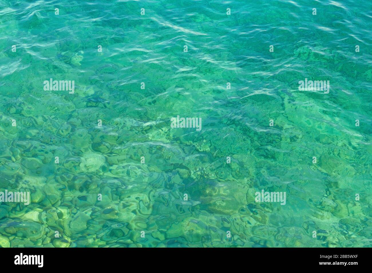 Blue green transparent lake water texture. Background of tranquil water. Summer vacation concept. Stock Photo