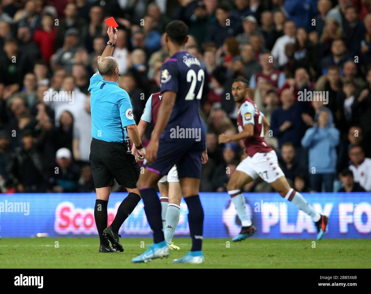 Match referee Mike Dean shows a red card to West Ham United's Arthur Masuaku (not pictured) Stock Photo