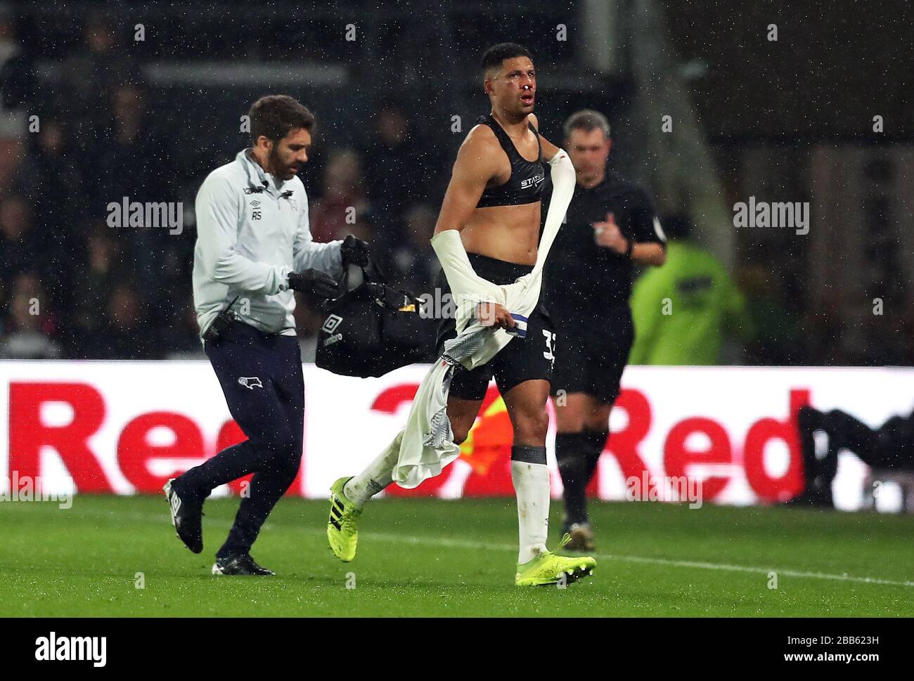 Derby County's Curtis Davies changes his shirt after receiving a kick from Wigan Athletic's Kieffer Moore (not pictured) Stock Photo
