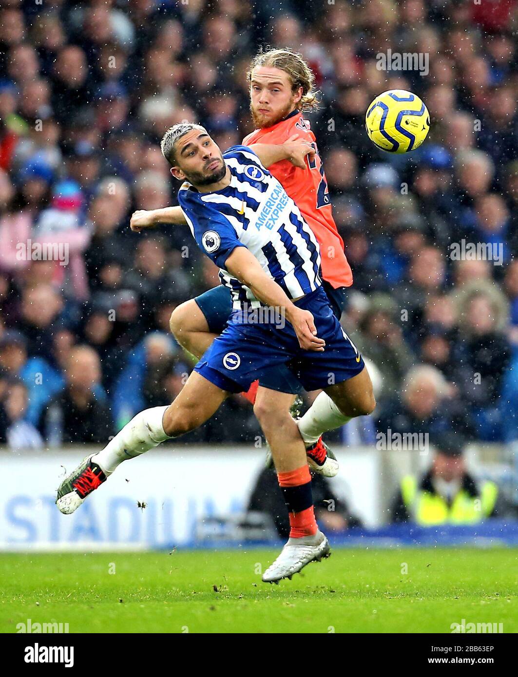 Brighton and Hove Albion's Neal Maupay (front) and Everton's Tom Davies battle for the ball Stock Photo