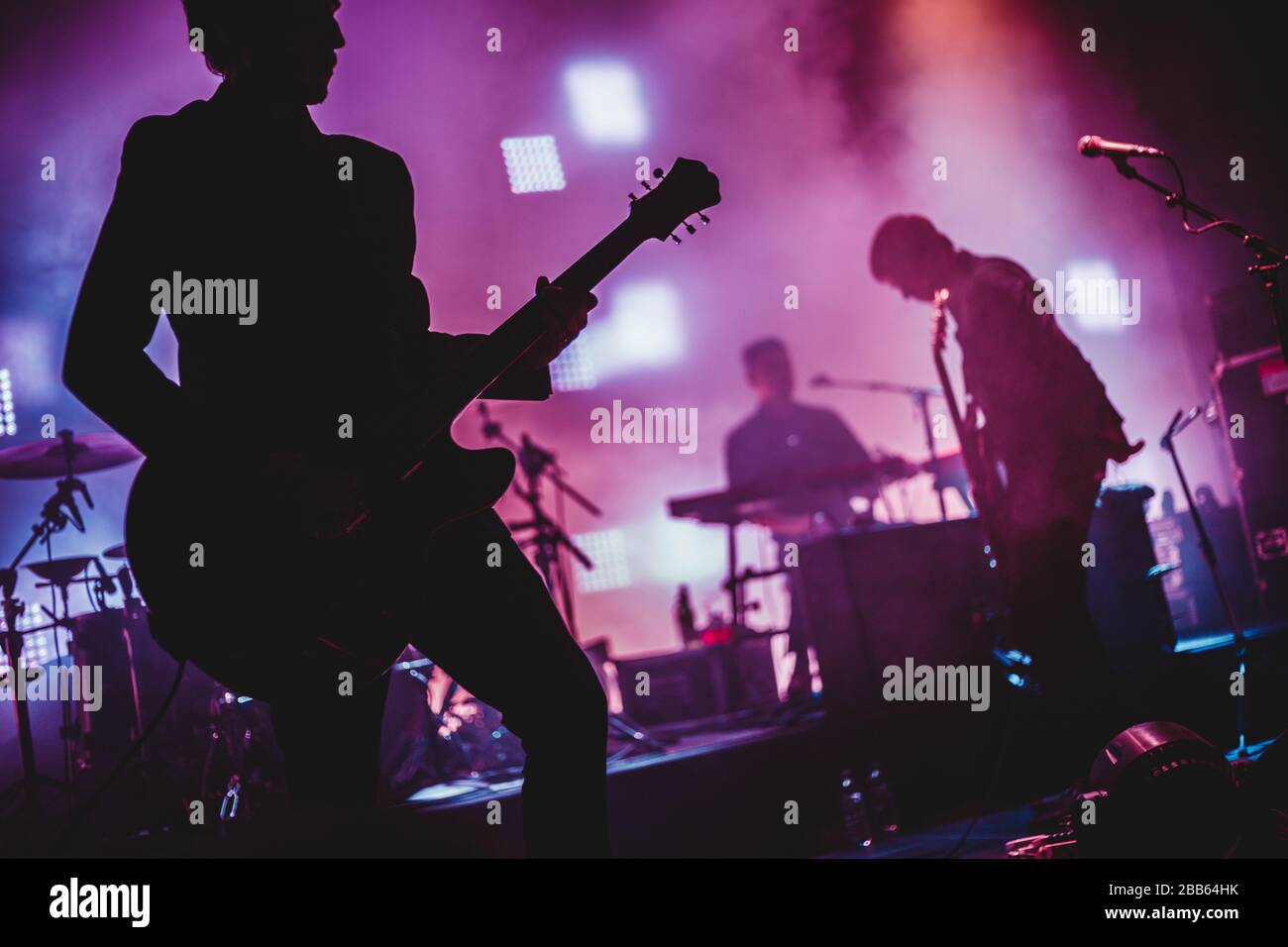 Blurred background light on rock concert with silhouette of musicians Stock Photo