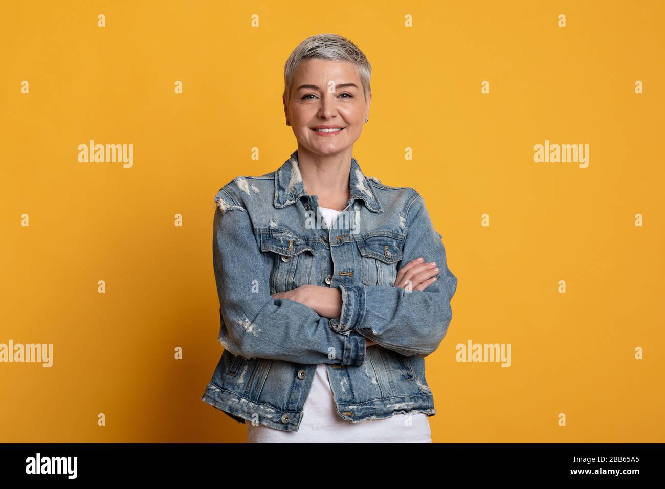 Portrait of confident middle aged woman posing with folded arms Stock ...