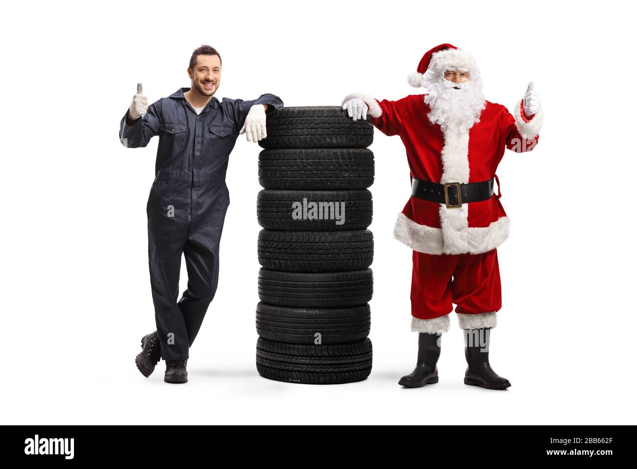Full length portrait of an auto mechanic and Santa Claus with a pile of ...