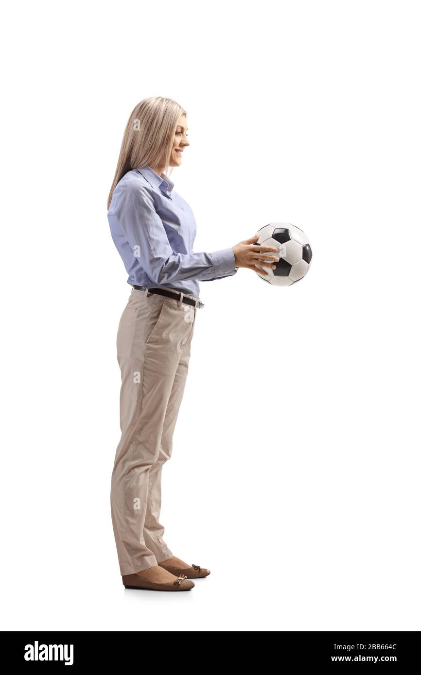 Full length profile shot of a woman in formal clothes holding a football isolated on white background Stock Photo