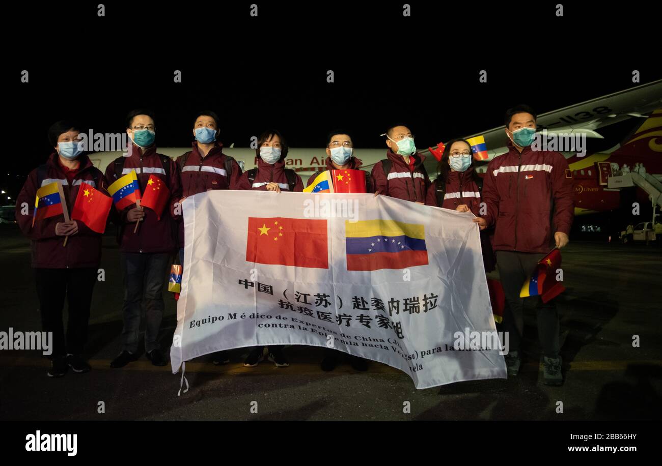 La Guaira, Venezuela. 30th Mar, 2020. Chinese medical experts pose at the Simon Bolivar International Airport, in La Guaira, Venezuela, on March 30, 2020. China has sent a team of medical experts to Venezuela to help the country fight the COVID-19 pandemic, Foreign Ministry spokesperson Hua Chunying announced Monday. The team has arrived on Monday, she said. Credit: Marcos Salgado/Xinhua/Alamy Live News Stock Photo