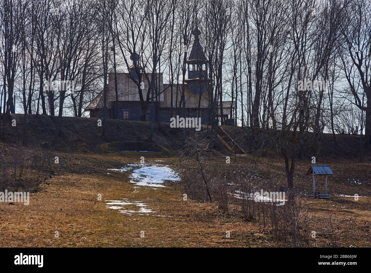 Ancient orthodox temple among trees. Landscape of central Russia. Windows, roof and doors are visible through branches. The village of Big Boldino Stock Photo