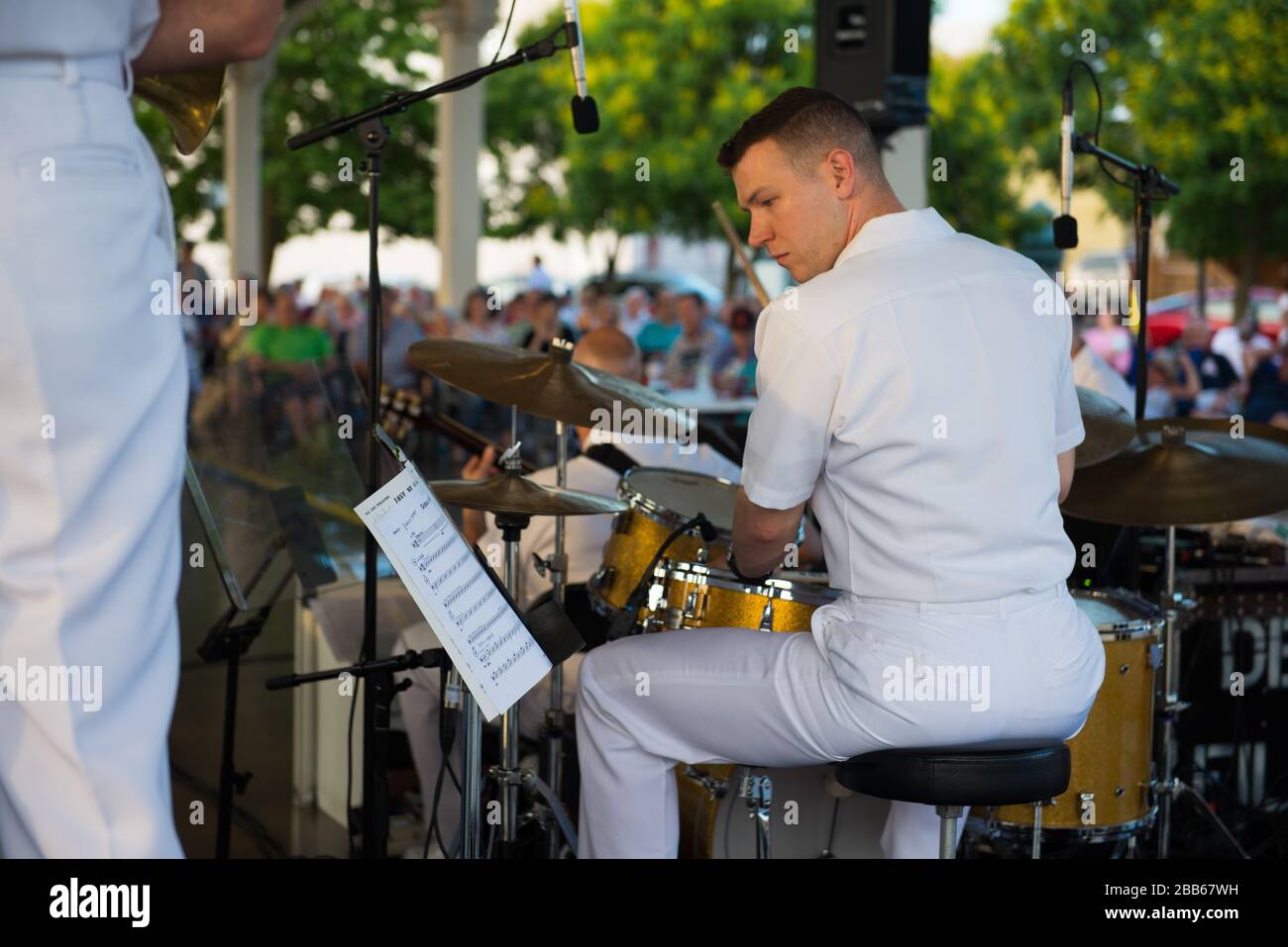 '170615-N-VV903-057 - Manassas, VA (June 15, 2017) Musician !st Class Kevin McDonald of United States Navy Band Commodores lays down the groove before an enthusiastic Summer audience at the Harris Pavillion in Manassas Virginia.  The United States Navy Band provides both military exposure and cultural enrichment to music lovers of all ages through its public concert series.  (U. S. Navy photo by Musician 1st Class David Aspinwall/Released); 15 June 2017, 19:33; 170615-N-VV903-057; United States Navy Band from Washington, D.C., USA; ' Stock Photo