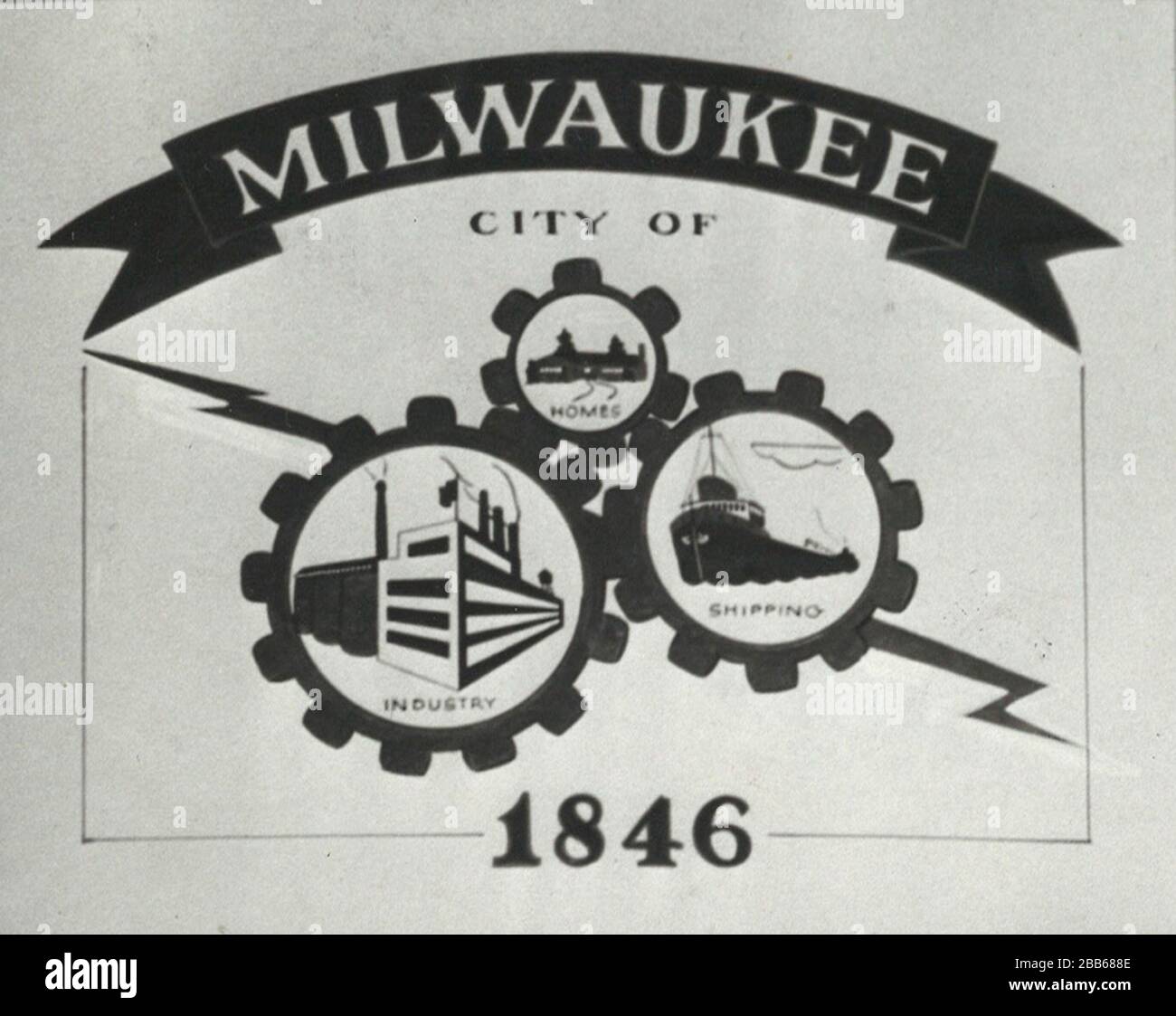 'English: A black-and-white rendition of the winning design in Milwaukee's 1950 flag design contest. It features a ribbon with the name Milwaukee over three gears labeled HOMES, INDUSTRY, and SHIPPING.  This design was never officially adopted by the city, though some elements were later re-purposed for Milwaukee's first official flag in 1954.; 1 January 1950; Created in Photoshop by user SixFourThree based on contemporaneous newspaper accounts.; Unknown author; ' Stock Photo