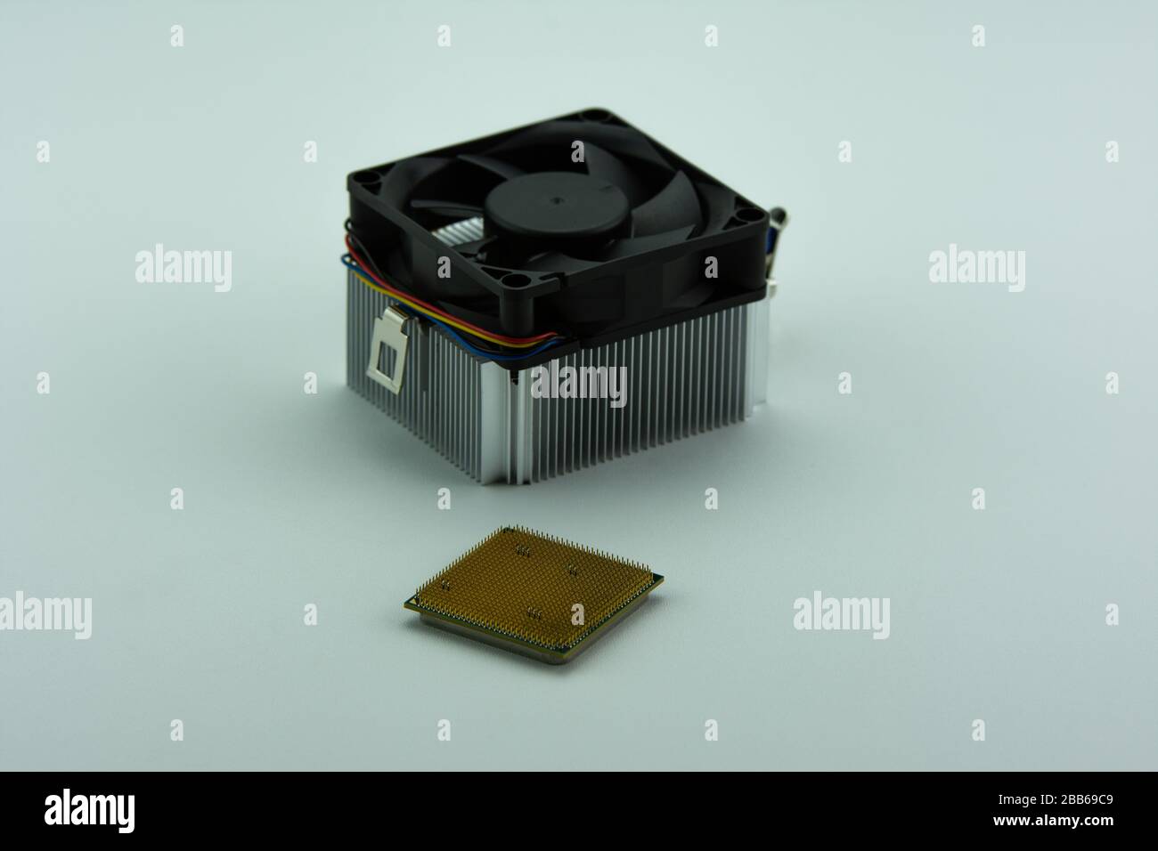Multi-core Central Processing Unit (CPU) and aluminium cooling fan isolated on white background. Stock Photo