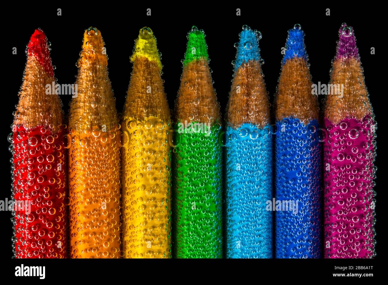 Multi coloured pencils submerged in water Stock Photo Alamy