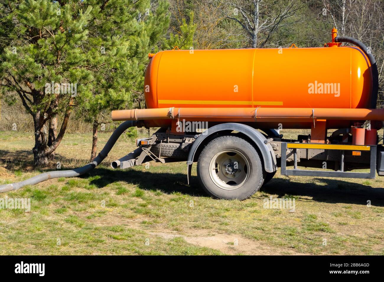 Sewer tank truck providing cleaning service outdoor. Specialized car, sewage pumping machine Stock Photo