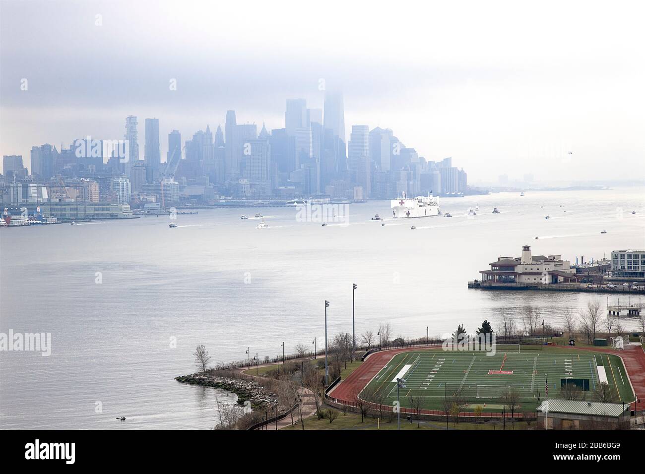 USNS Comfort NYC - Mother nature added to the somber mood as the US Naval Hospital Ship Comfort arrives in Manhattan in New York City. Stock Photo