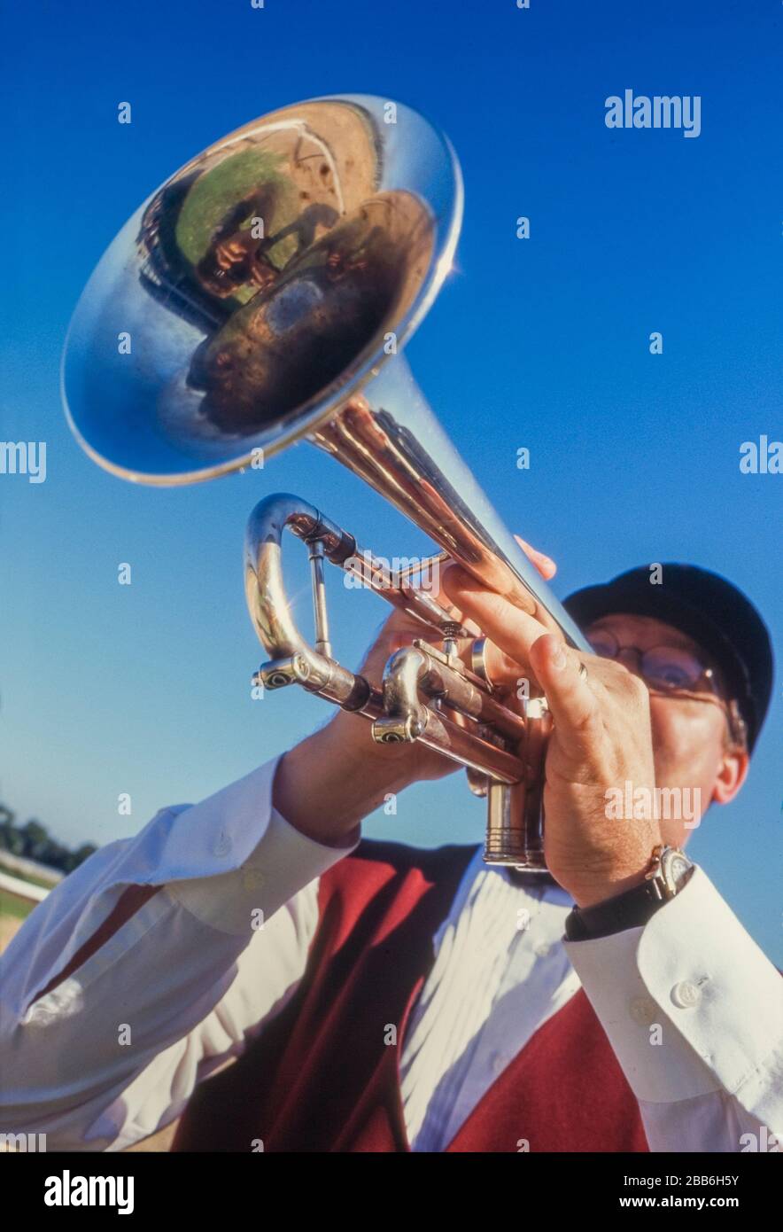 Bugler gives call to post at Horse racing venue Stock Photo
