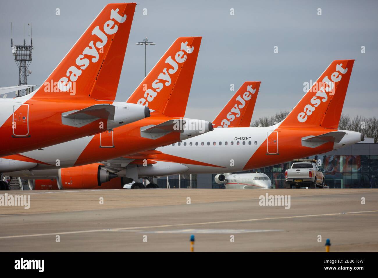 Picture dated March 30th 2020 shows grounded EasyJet planes at Luton Airport on Monday morning after the company grounded the fleet of aircraft due to the Coronavirus outbreak.  Rows of EasyJet planes were seen lined up at Luton Airport today (Mon) after the company grounded its entire fleet of aircraft due to the coronavirus pandemic.  The airline’s 344 planes will now remain grounded and the company has worked with union Unite to agree two-month furlough arrangements for cabin crew, which means they will be paid 80 per cent of their pay. Stock Photo