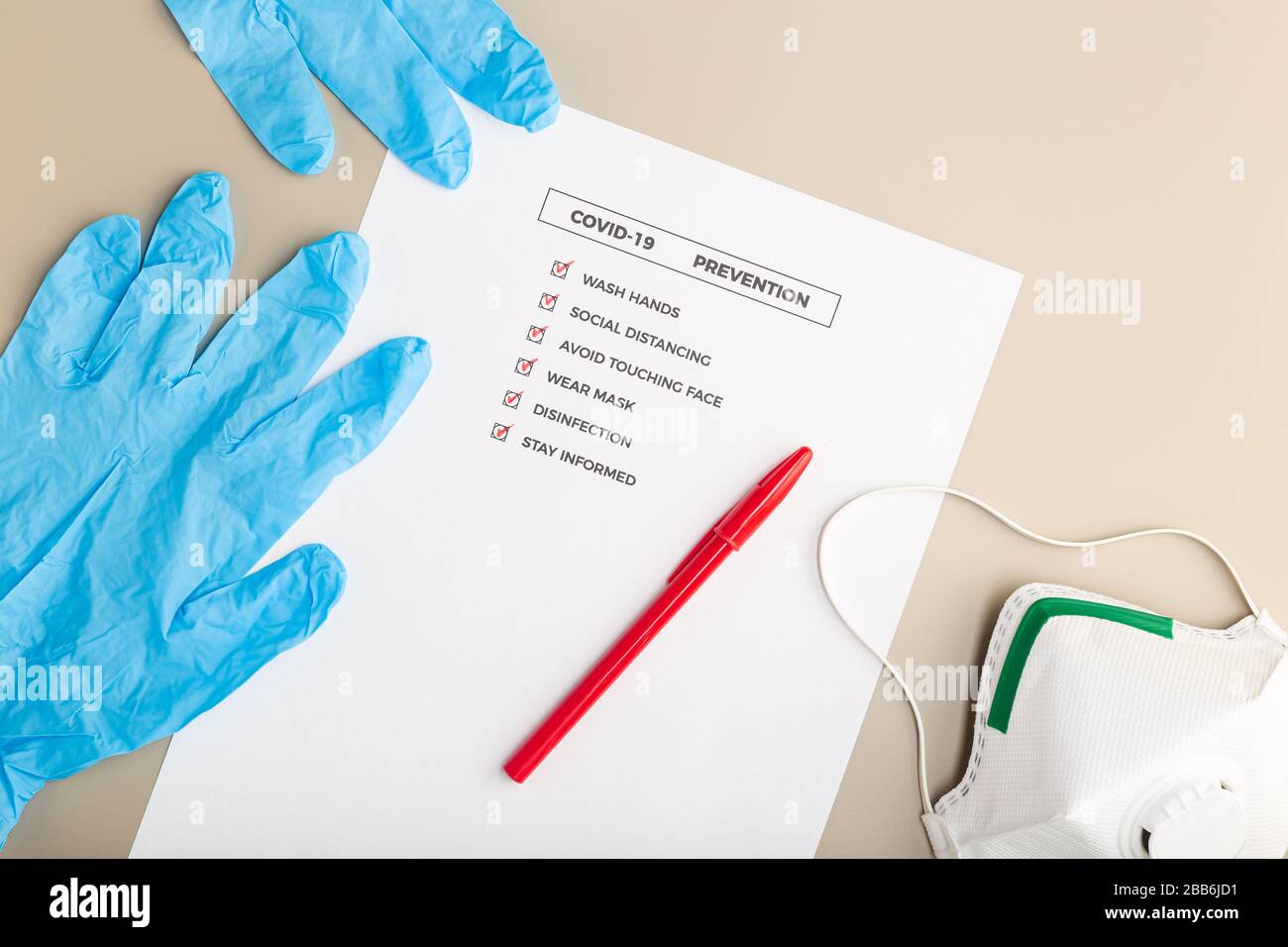 Coronavirus advice or prevention concept. Top view of a COVID-19 prevention check list and safety equipment Stock Photo