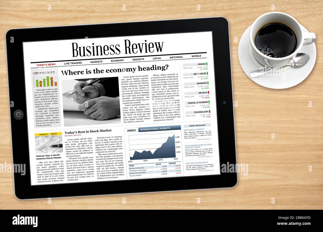 Daily news on tablet with a cup of coffee. Stock Photo