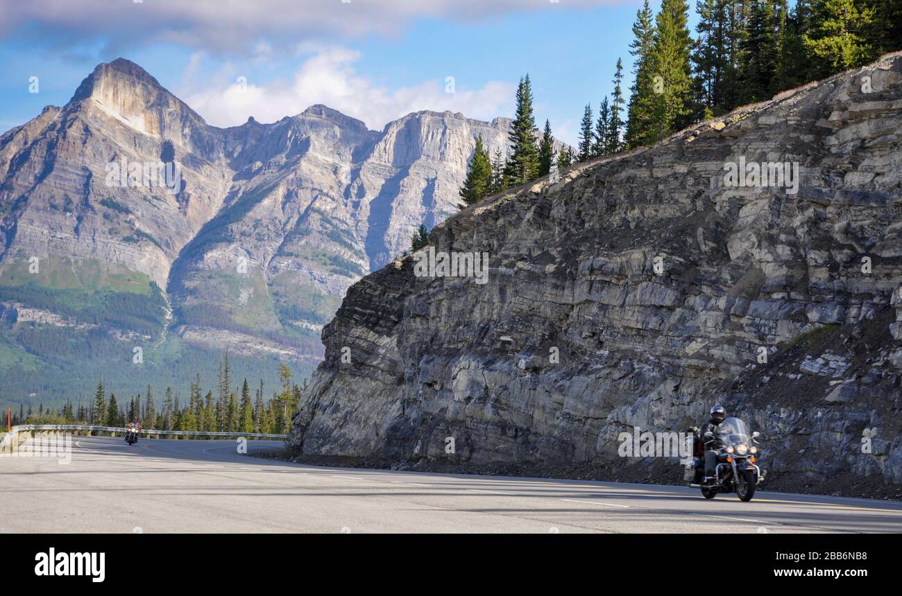 Two motorbike riders driving through the Rocky mountains, Canada Stock Photo