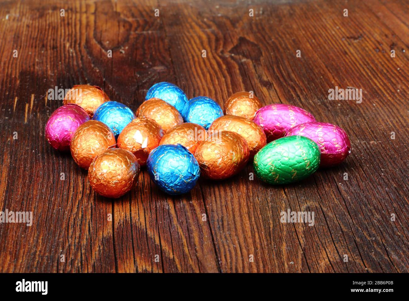 Different colored easter eggs on a wooden board Stock Photo