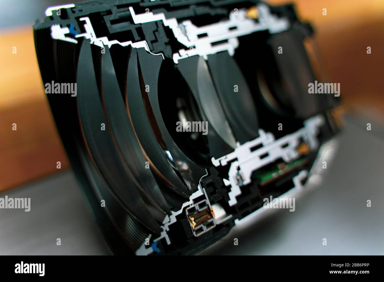 Mirrorless camera lens cut in half, visible elements and focusing