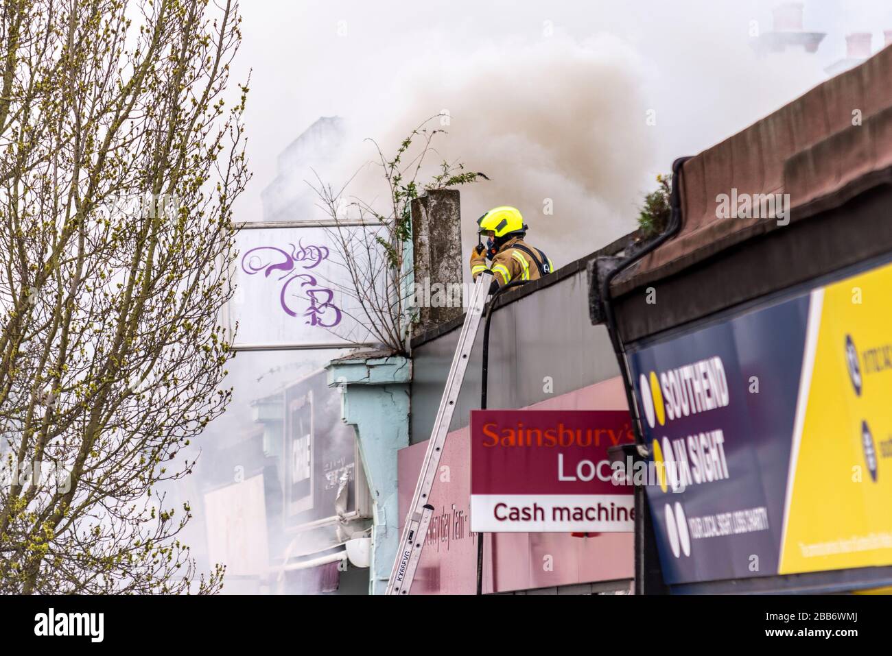 Hamlet Court Road, Westcliff on Sea, Essex, UK. 30th March 2020. A fire next to a Sainsbury’s supermarket has created unwelcome issues during the COVID-19 Coronavirus pandemic. It required the attendance of a large number of emergency services, has affected one of the largest food suppliers in the area and has attracted groups of people not complying with social distancing guidelines. A spokesman for Essex Police said: 'We were called following a fire within a shop at around 5pm. While carrying out a search of the property over 500 cannabis plants were found' Stock Photo