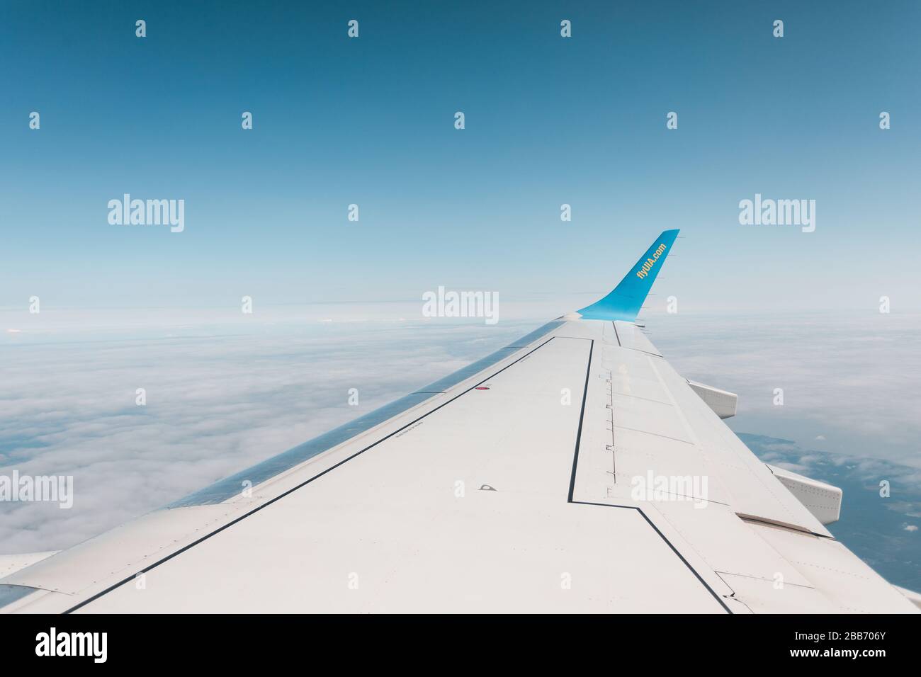 Wing of an airplane during a flight against a blue sky Stock Photo - Alamy