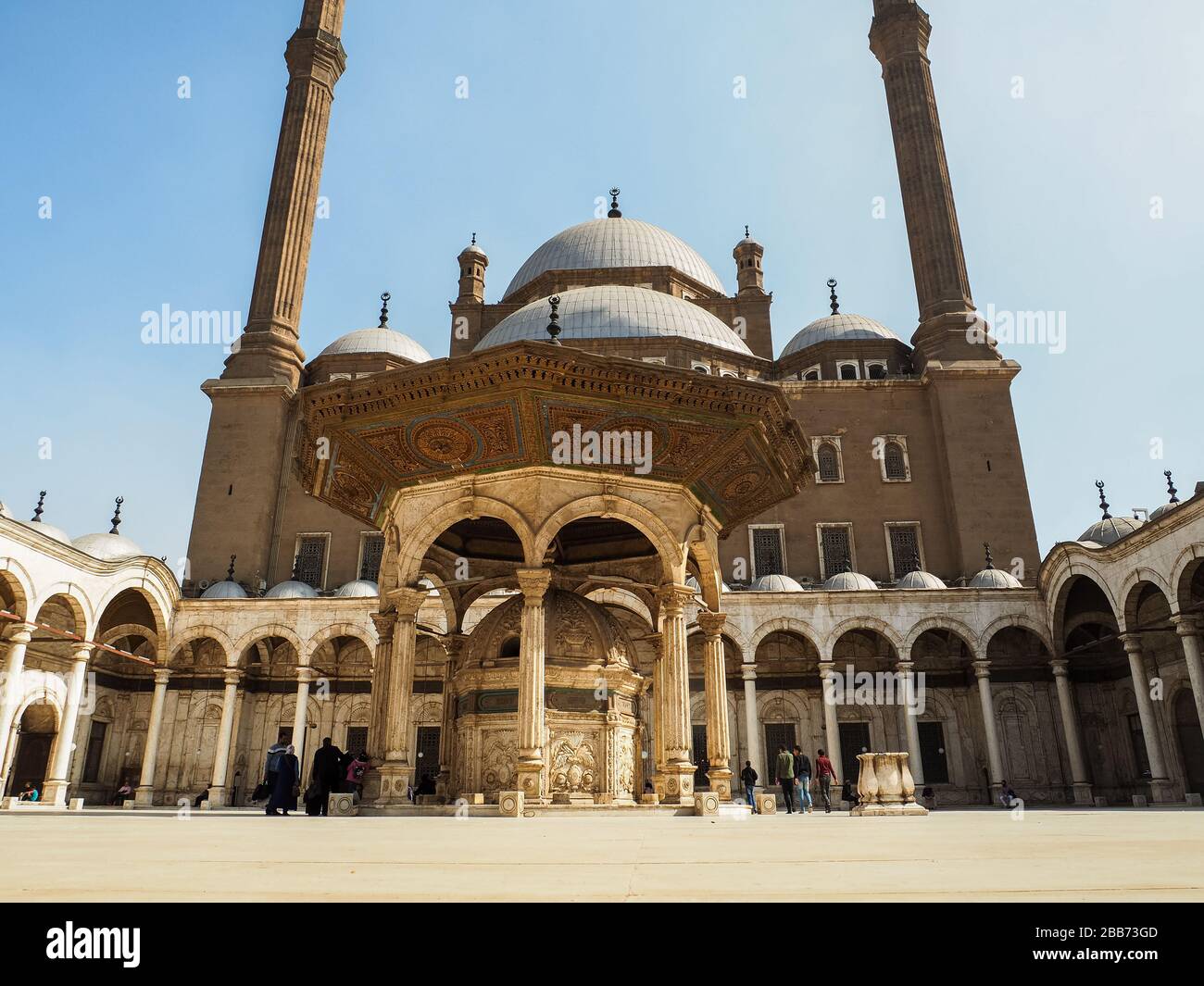 Cairo, Egypt, February 2020, some tourists strolling around the patio of the muhammad ali mosque in cairo Stock Photo