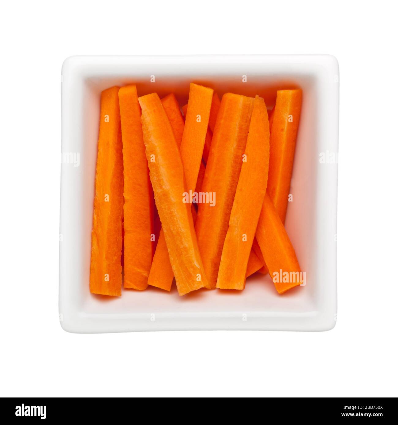 Cut carrot sticks in a square bowl isolated on white background Stock Photo