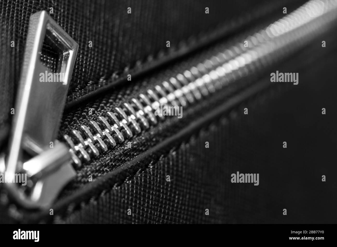 Close up of zip fastener on black women's handbag Stock Photo