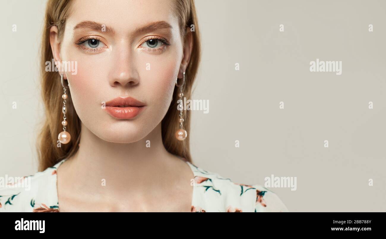 Woman wearing gold earrings hi-res stock photography and images - Alamy