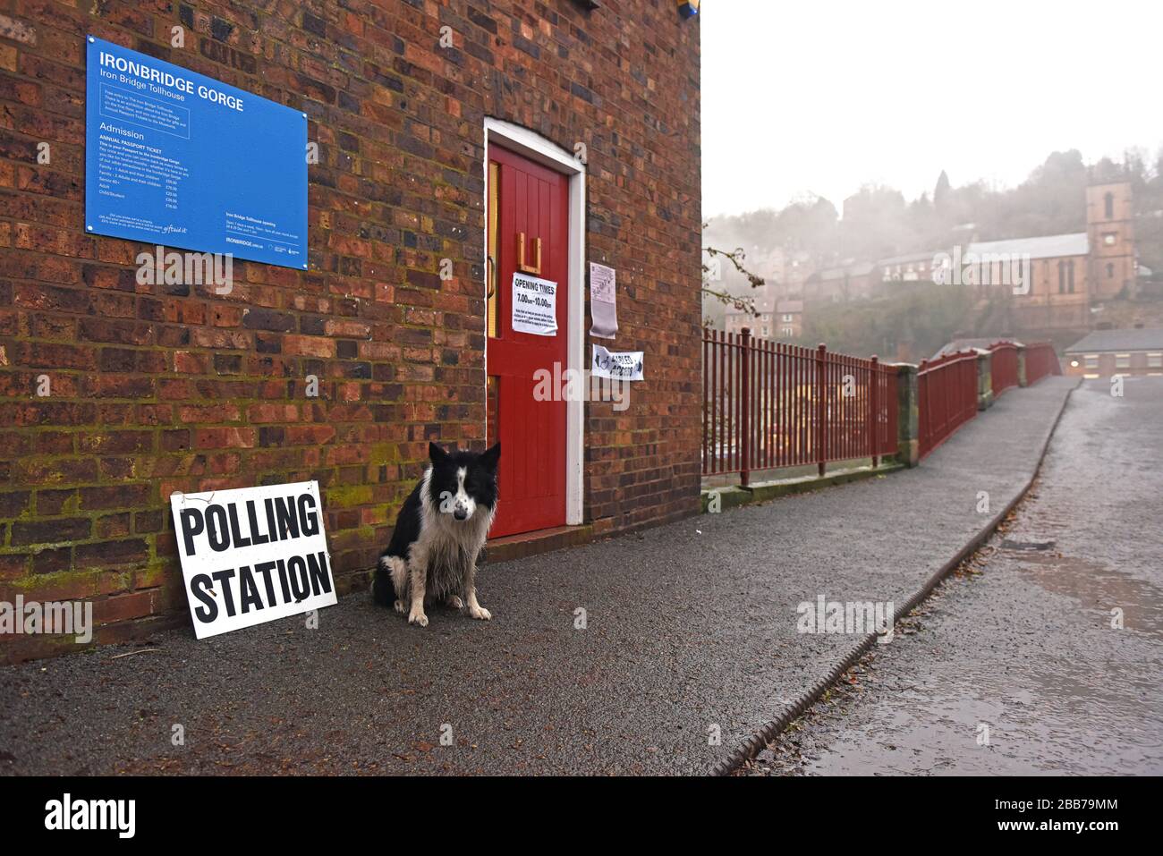 Voting at General Election 2019 in Coalbrookdale while dog waits in the rain. Stock Photo
