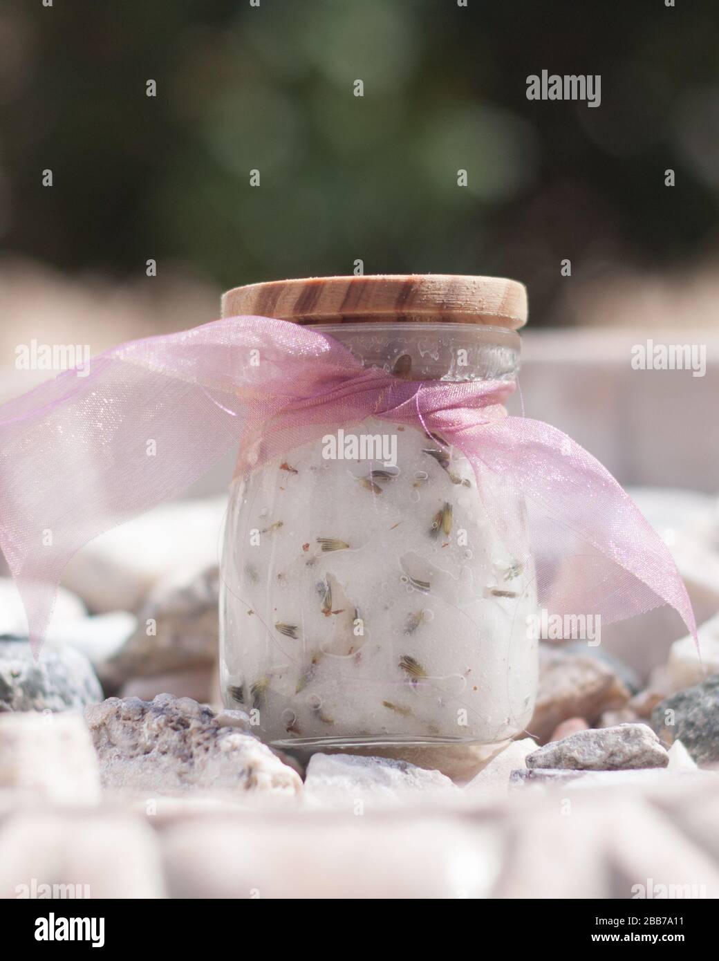 Sugar scrub glass jar, wood lid with purple ribbon Stock Photo