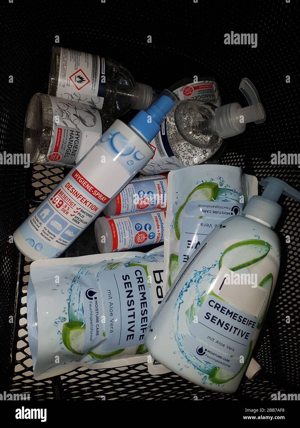 Hand soaps and germicide / disinfectant hoarding ' Hamsterkäufe ' - full shopping basket - pile of products - fear of epidemic corona virus / covid-19 Stock Photo