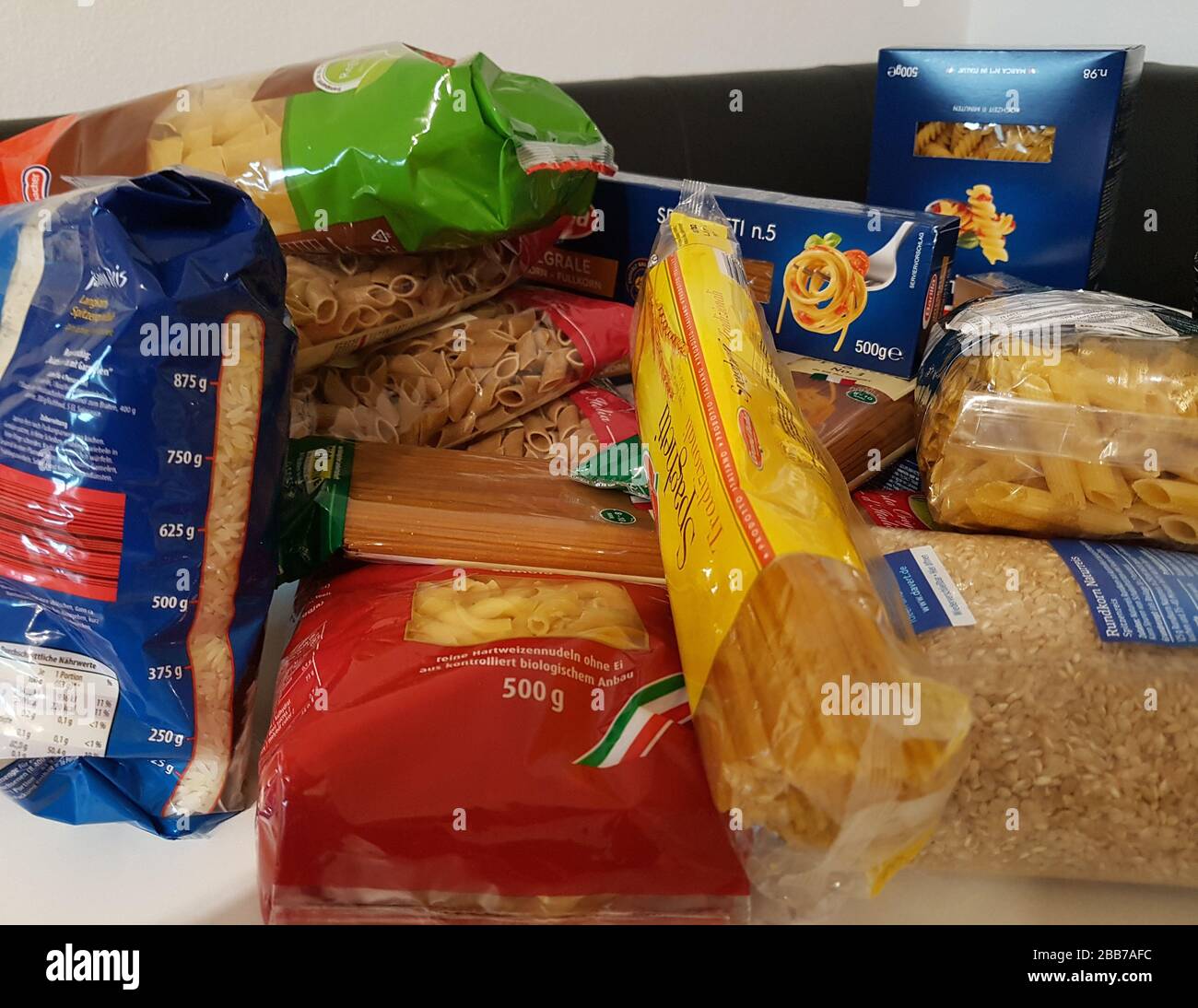 Non-perishable food hoarding ' Hamsterkäufe ' like noodles - full shopping basket shelf - pile of products - fear of epidemic corona virus / covid-19 Stock Photo