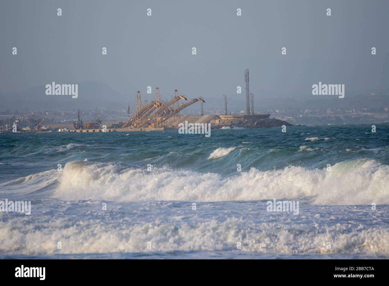 Maritime port of Garrucha (Spain) with several cranes and the Mediterranean sea in the foreground Stock Photo