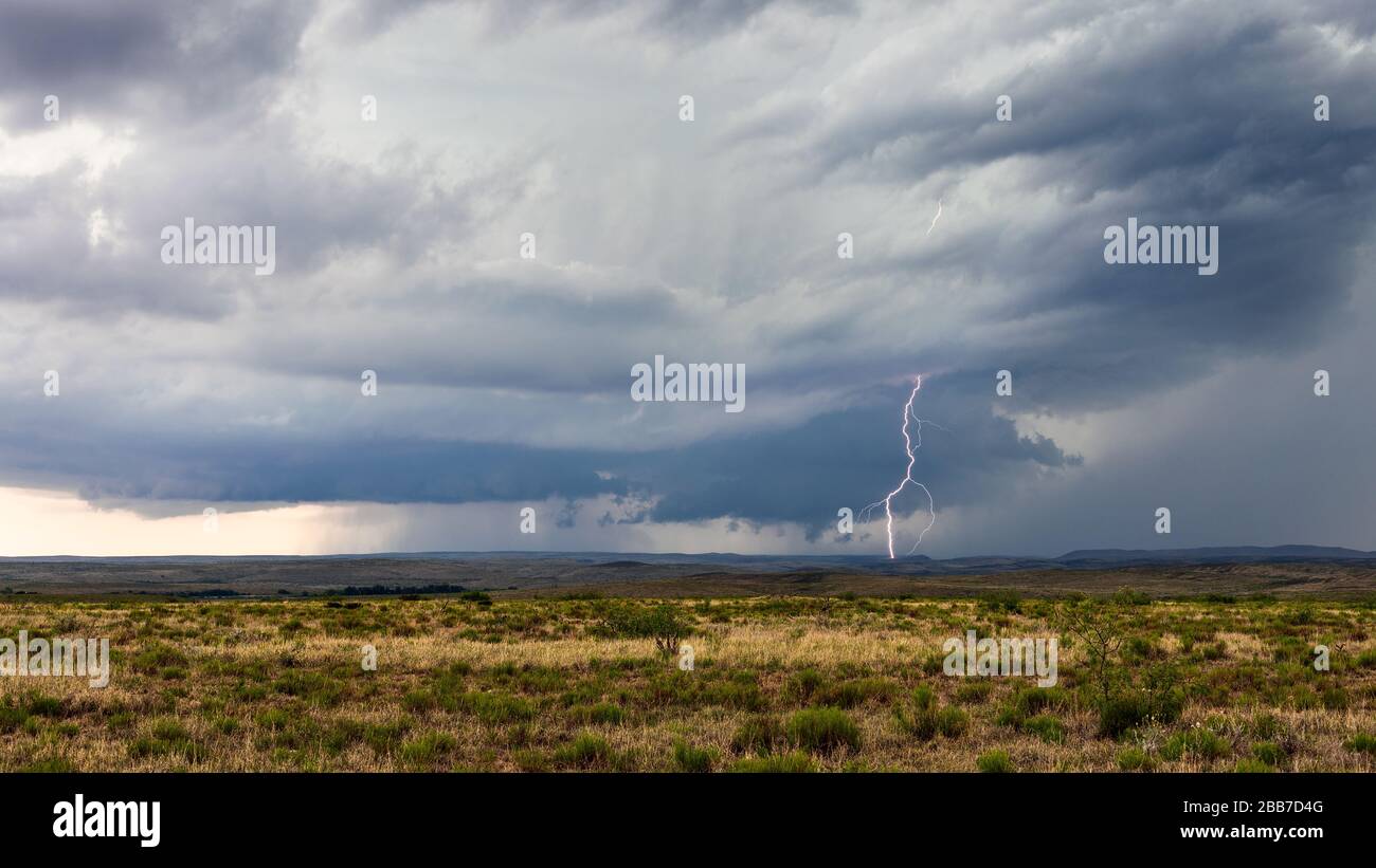 Wall cloud and lightning strike from a supercell thunderstorm in New Mexico Stock Photo