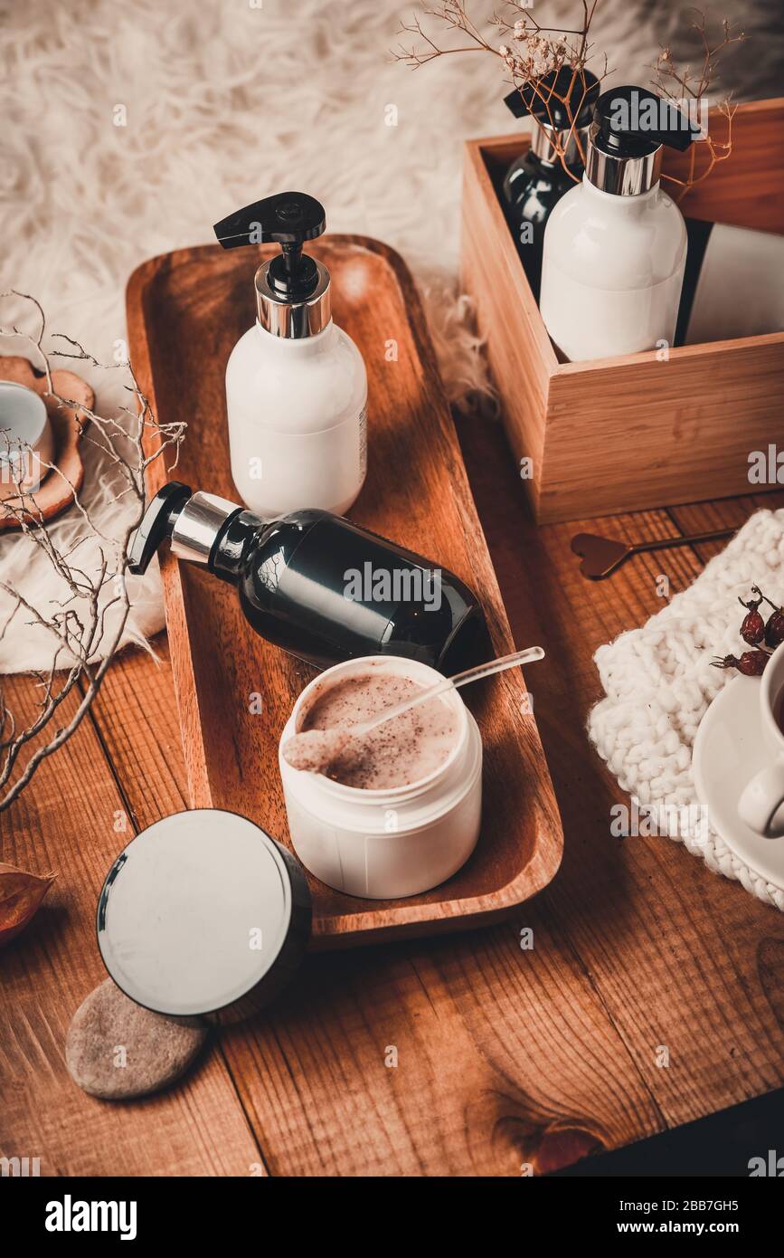 Cosmetic bottles with cosmetics for body care on a wooden table. Spa set on a wooden background. Blank label for branding mock-up Stock Photo